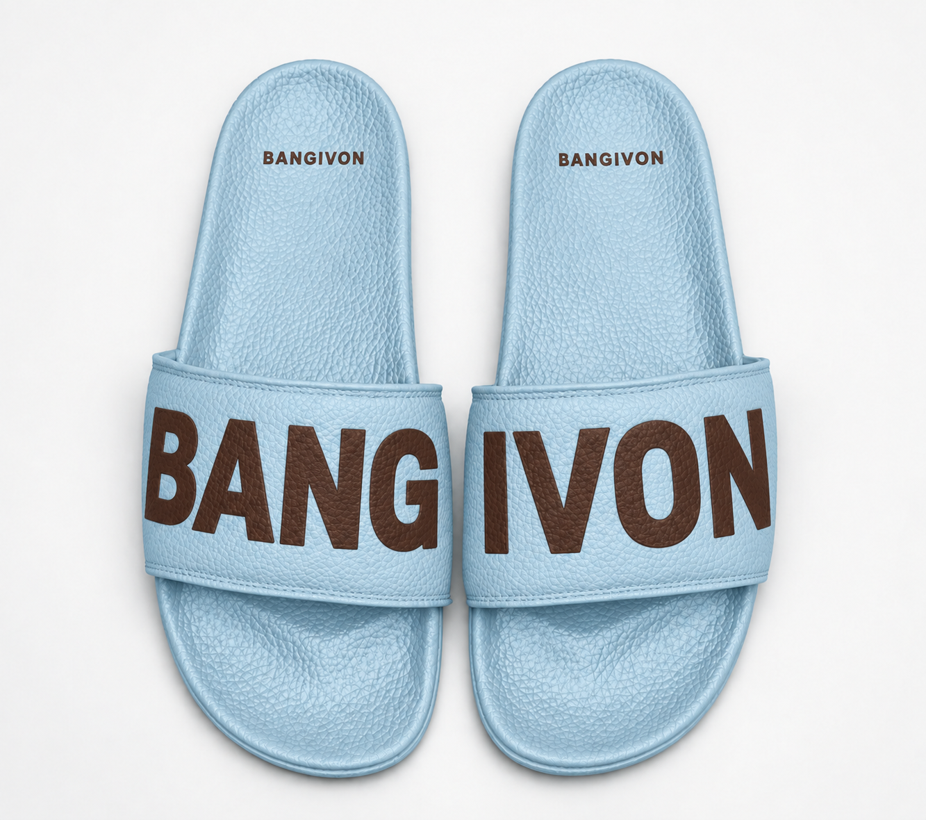 BANGIVON single-band slide sandals in Ice Blue / Cocoa, with BANG and IVON block lettering across the pair