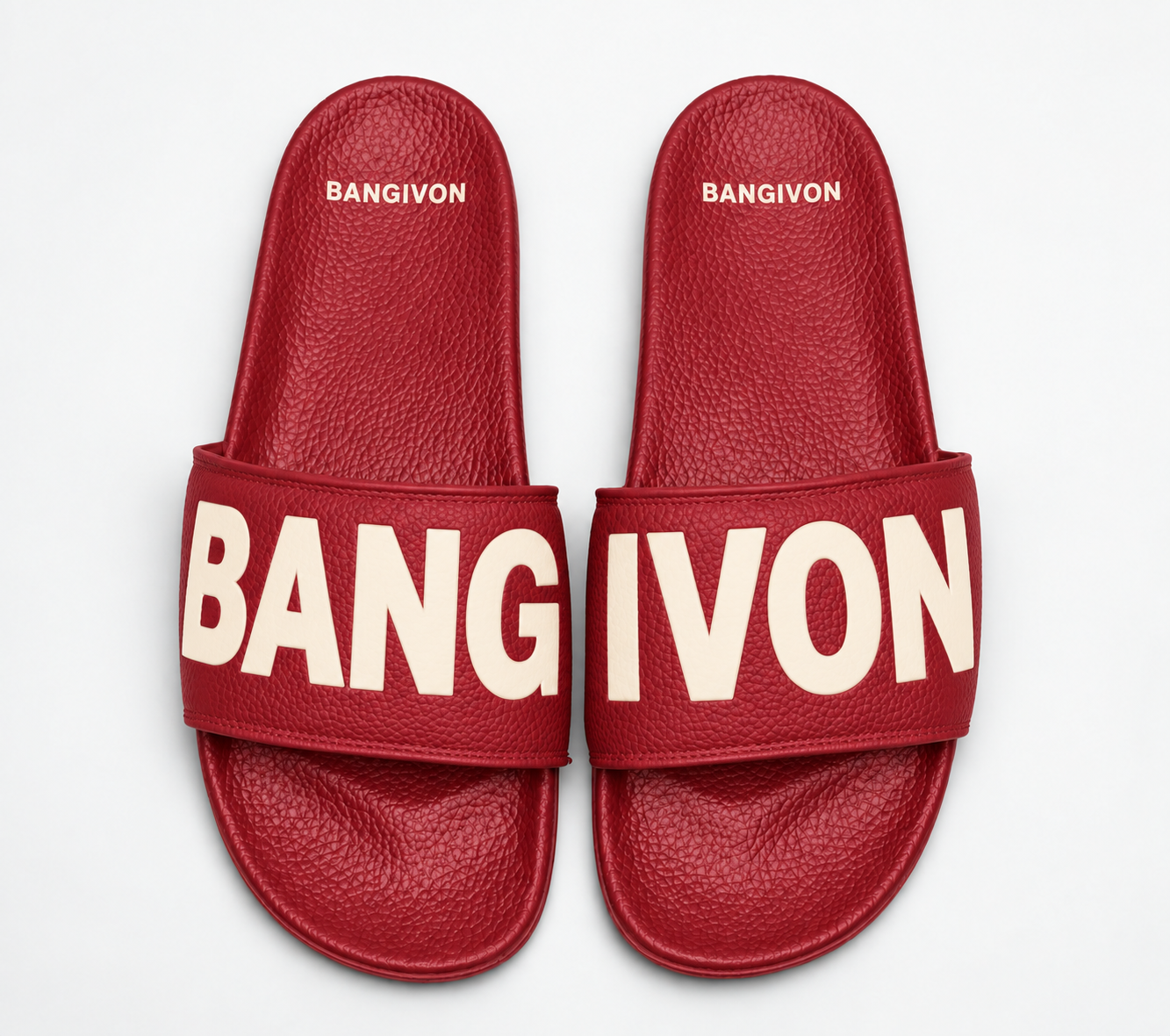 BANGIVON single-band slide sandals in Cherry Red / Cream, with BANG and IVON block lettering across the pair