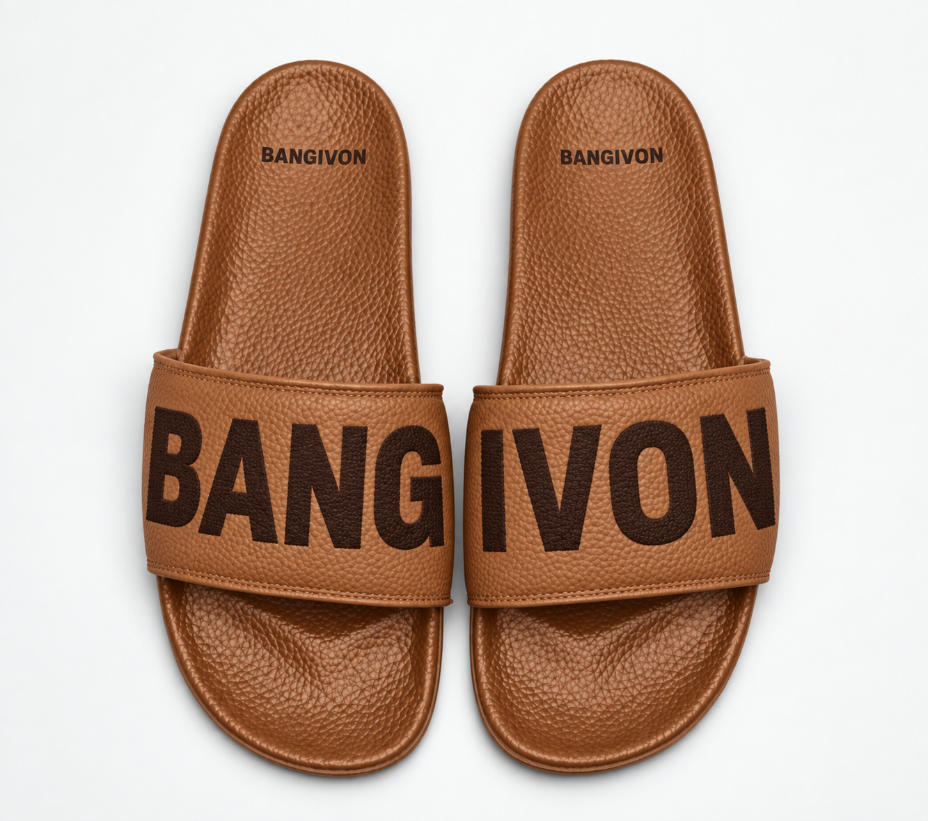 BANGIVON single-band slide sandals in Caramel / Espresso, with BANG and IVON block lettering across the pair